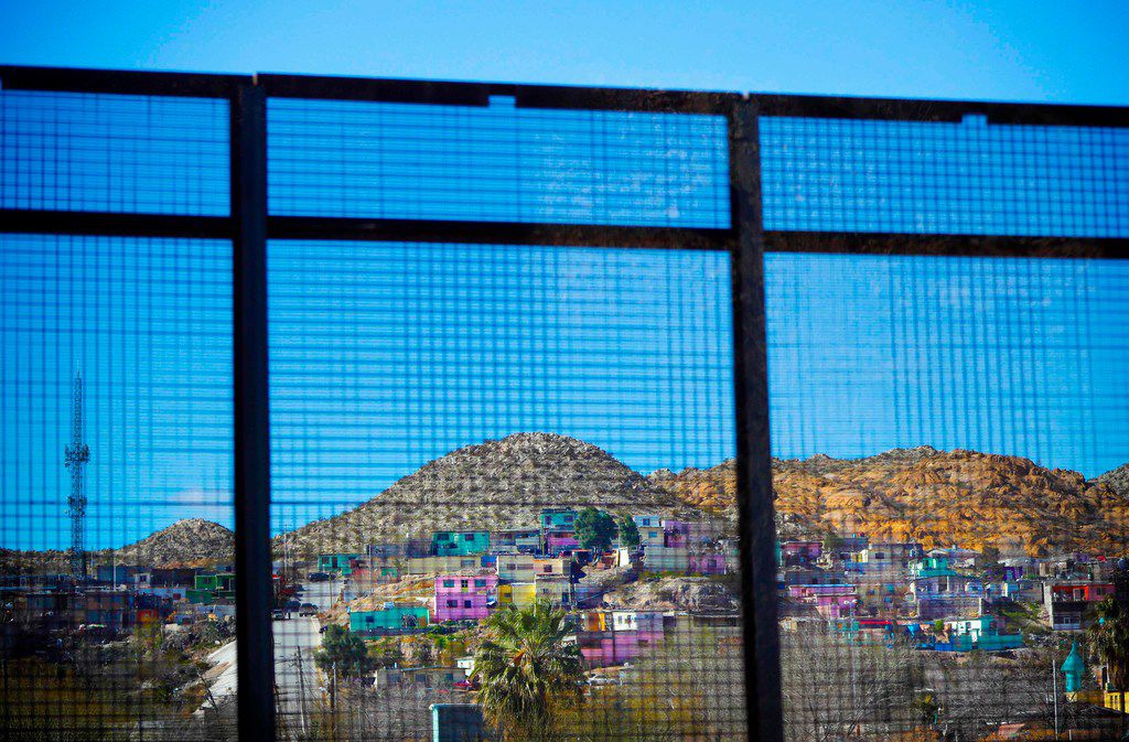 Residential homes in the Mexican city of Ciudad Juarez seen through border fencing during...