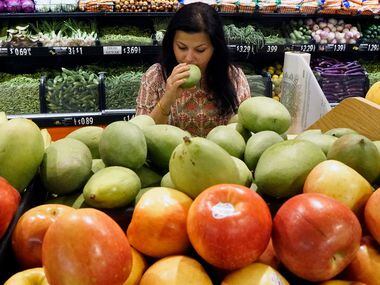 Sapna Punjabi-Gupta checks out the green raw mango at the India Bazaar in Irving.