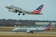 An American Airlines A319 takes off as a A321 taxis at DFW Airport on Sunday, Jan. 15, 2023.