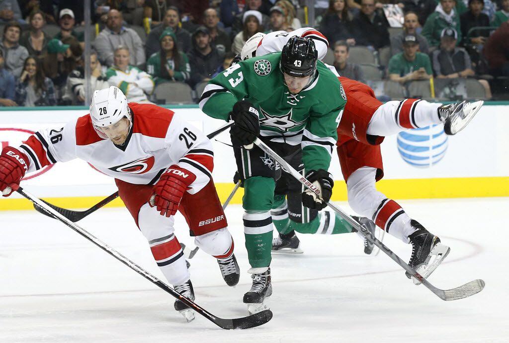 Dallas Stars right wing Valeri Nichushkin (43) sends Carolina Hurricanes center Riley Nash (20) flying as they collide with Carolina Hurricanes defenseman John-Michael Liles (26) in the first period at the American Airlines Center in Dallas, Tuesday, December 8, 2015.  (Tom Fox/The Dallas Morning News)