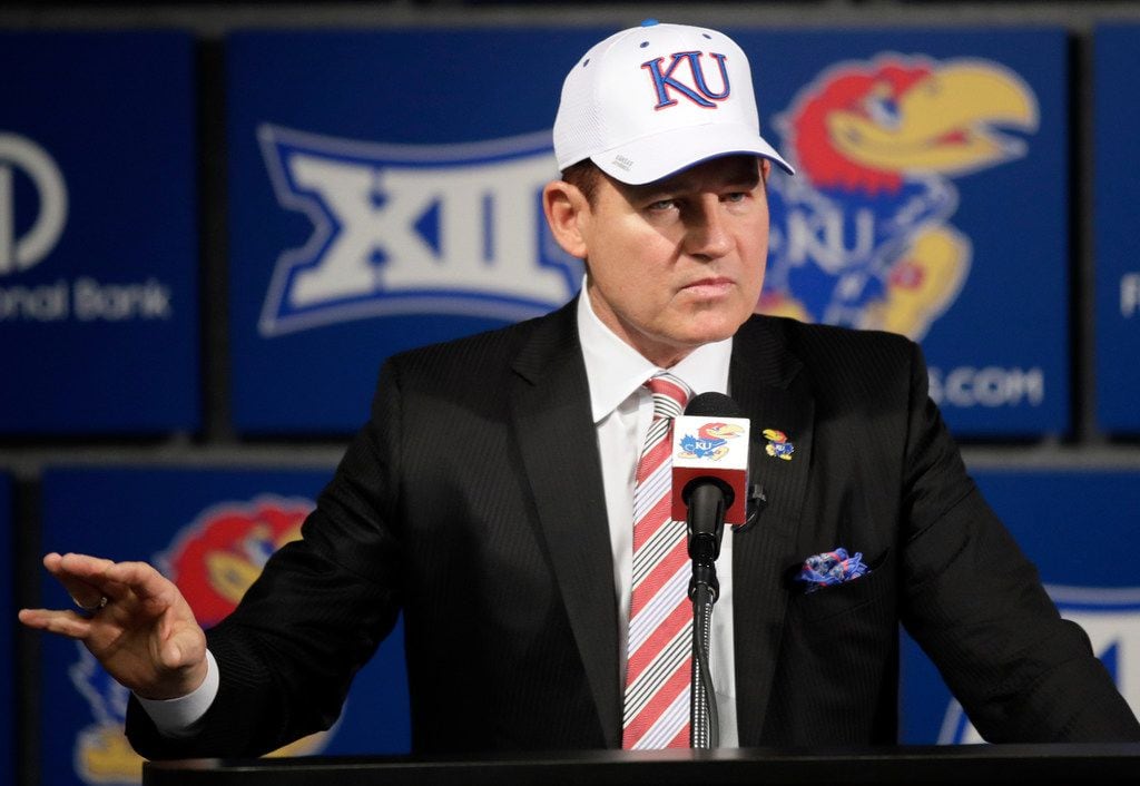 University of Kansas new football coach Les Miles makes a statement during a news conference...