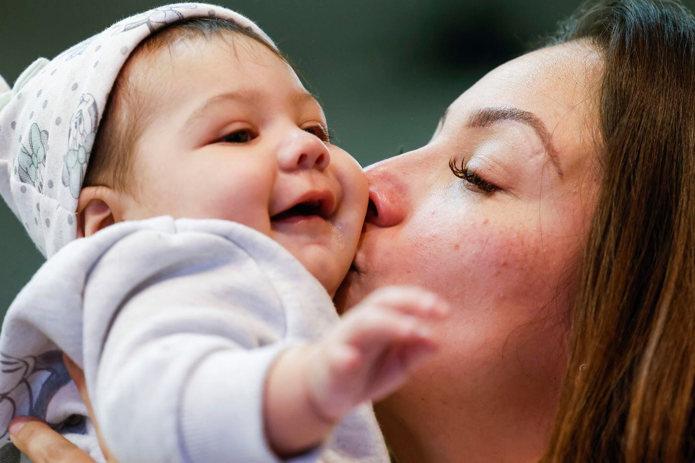 Mirtha Robles, mother of late Gabriel Zamora, 14, kisses her seven-month-old grand daughter...