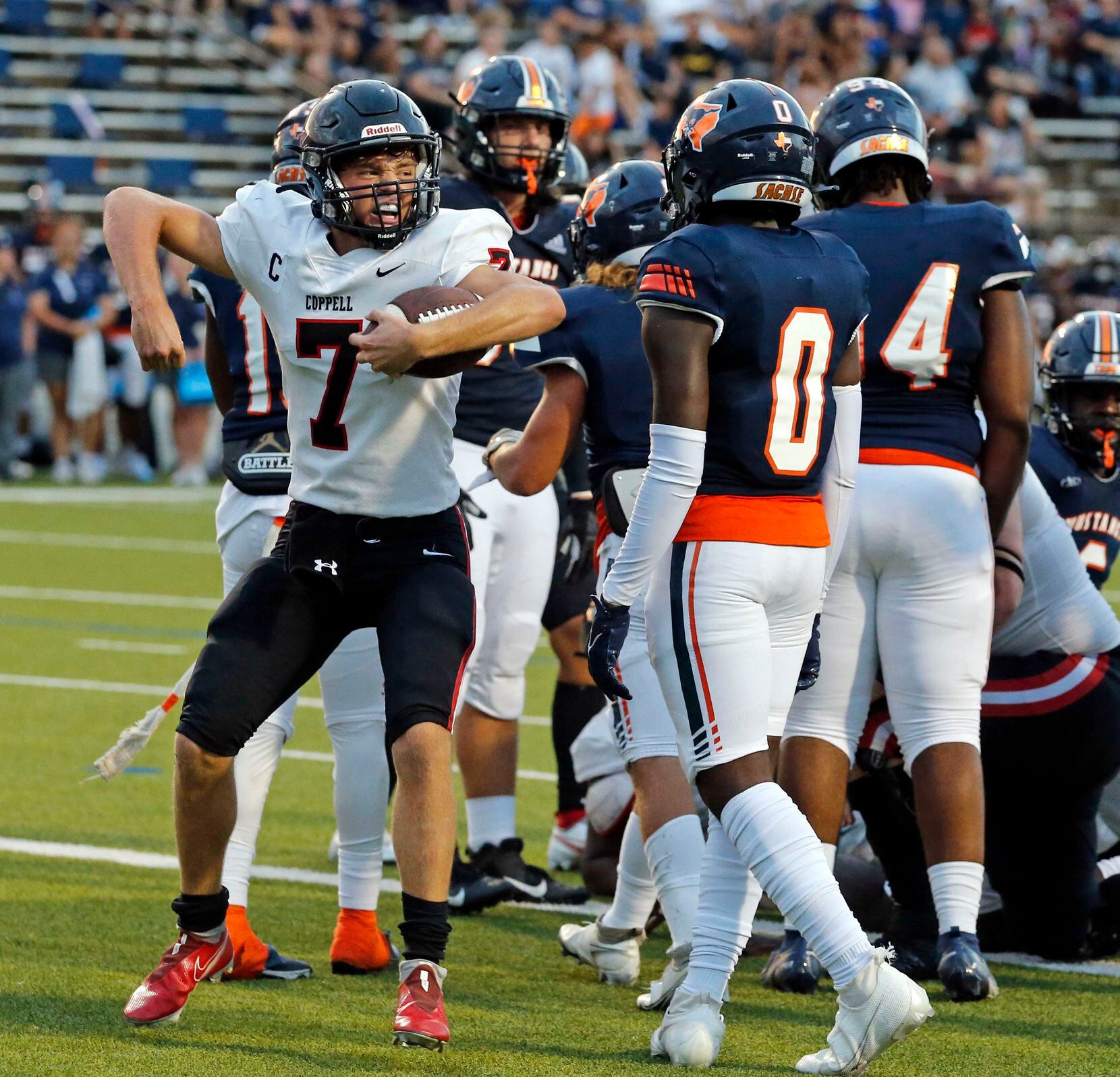 Coppell QB Jack Fishpaw (7) celebrates after scoring a touchdown during the first half of a...