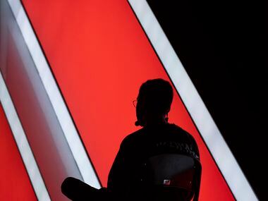 A technician sits patiently on stage during OpTic Texas' Call of Duty League Tournament at...