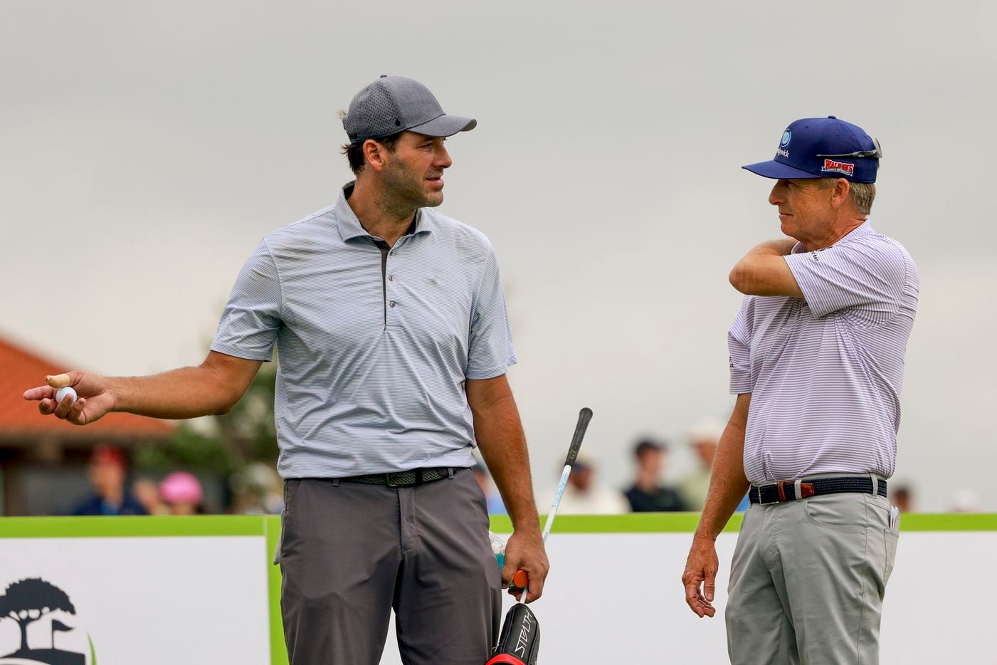 Former Dallas Cowboys quarterback Tony Romo (left) talks with professional golfer David Toms...