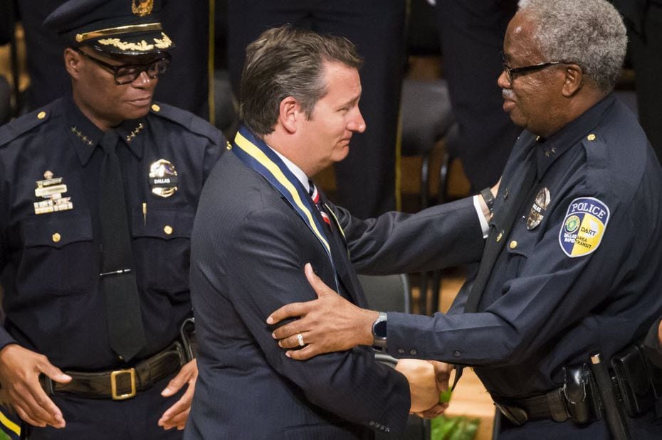 Sen. Ted Cruz shakes hands with DART police chief J.D. Spiller as Dallas police chief David...