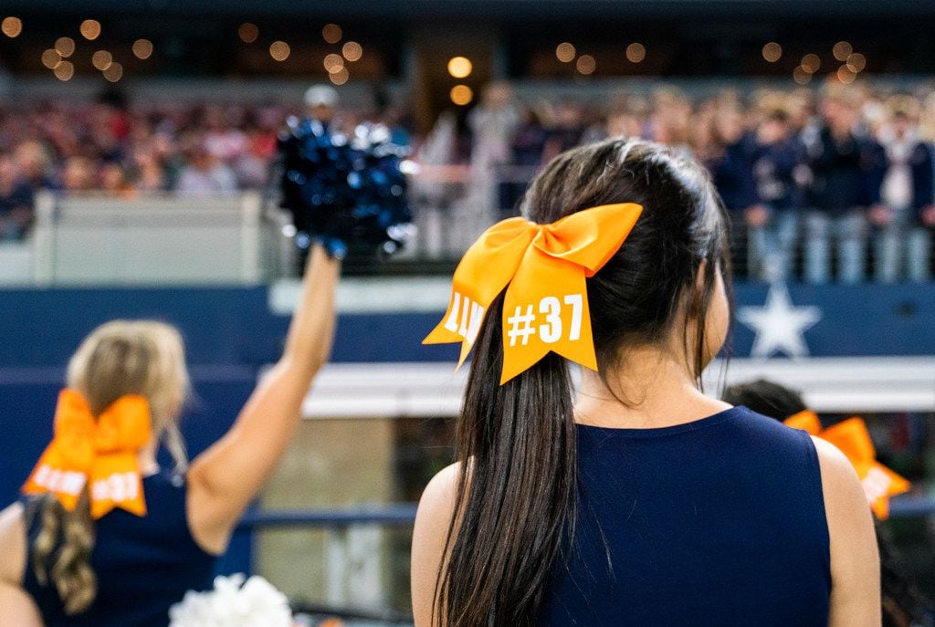 Allen cheerleaders wear the number 37 on their cheeks to honor Marquel Ellis Jr., a sophomore football player who was shot and killed at a party last week, during the first quarter of a Class 6A Division I area-round high school football playoff game between Allen and Rockwall on Friday, November 22, 2019 at AT&T Stadium in Arlington. (Ashley Landis/The Dallas Morning News)