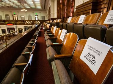 In the guest seating areas in the chamber of the house at the Texas Capitol in Austin, signs were placed enforcing physical distancing.  The legislature opens its session Tuesday amid a pandemic, economic recession and political turmoil.