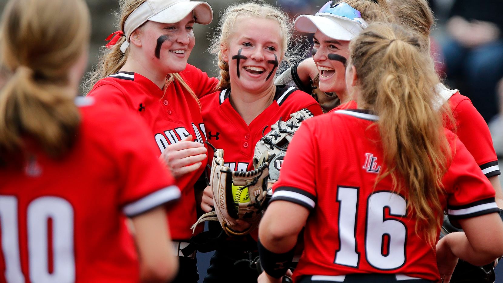 Lovejoy pitcher Jade Owens (center) is congratulated by her team after getting out of a jam...