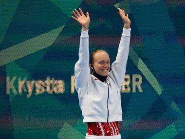 USA’s Krysta Palmer waves as she is introduced before the start of the women’s 3 meter...