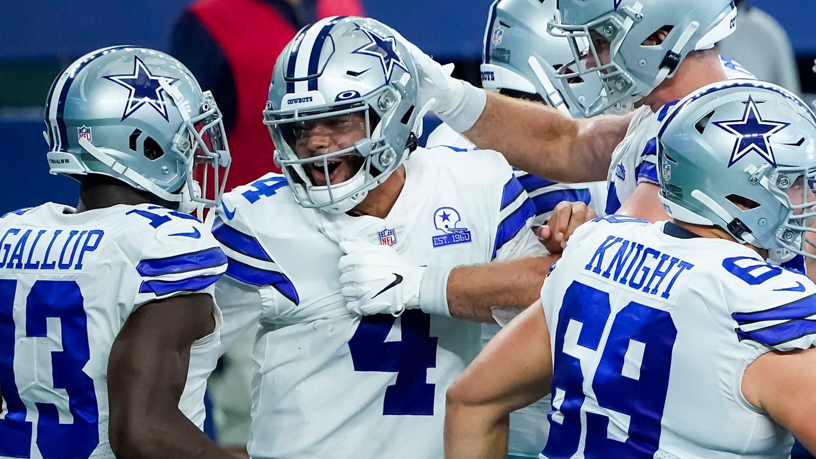 FILE — Dallas Cowboys quarterback Dak Prescott (4) celebrates after catching a touchdown  pass from wide receiver Ced Wilson during the second quarter of an NFL football game against the New York Giants at AT&T Stadium on Sunday, Oct. 11, 2020, in Arlington.