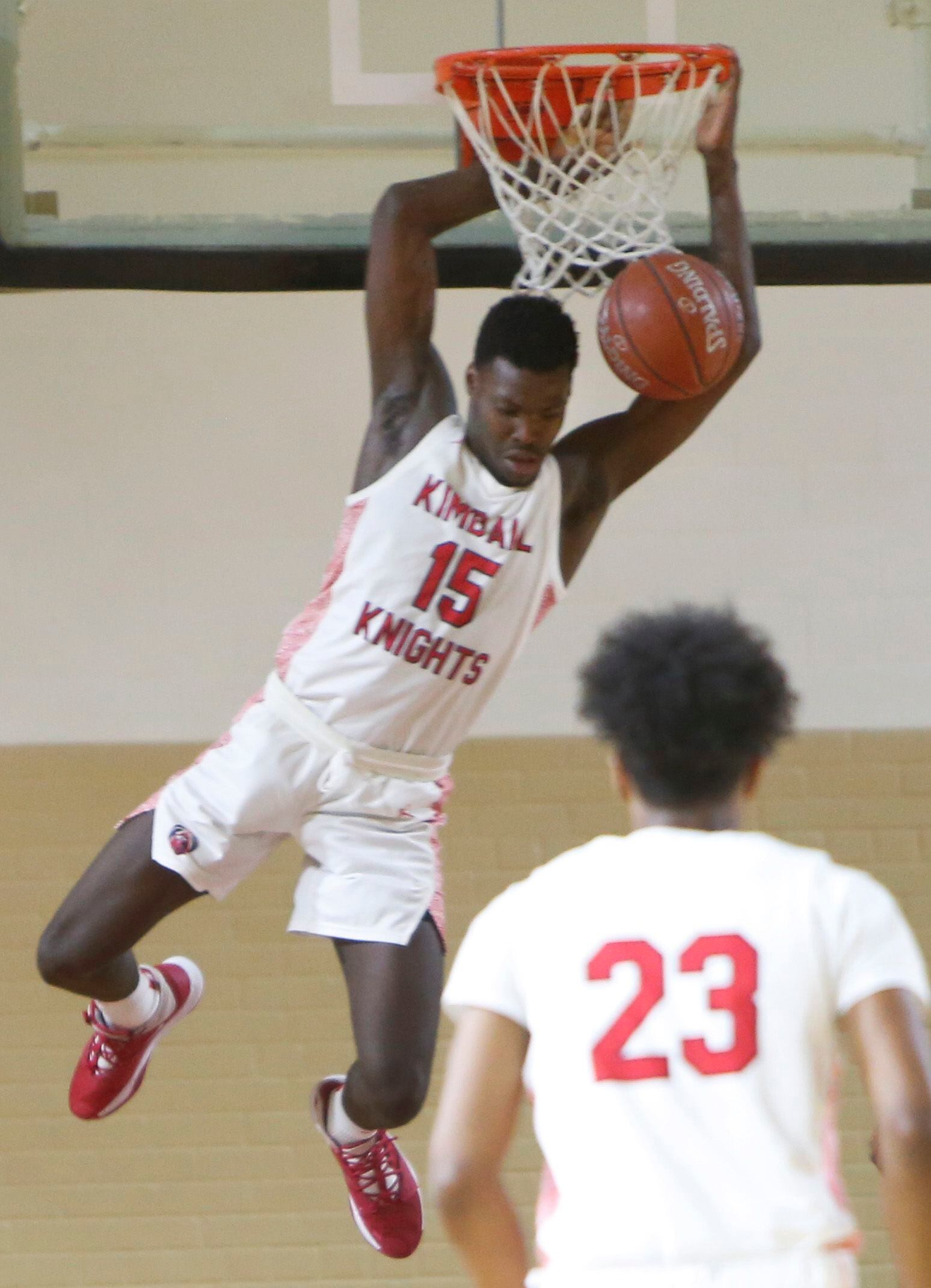 Dallas Kimball forward Kyron Henderson (15) finishes a fast break with a dunk during first...