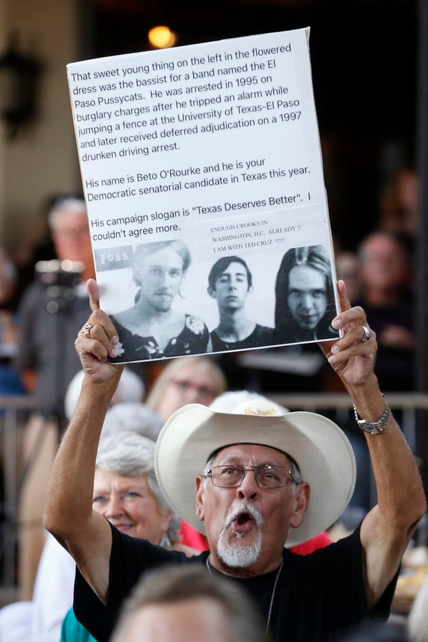 Quintin Williams holds a sign criticizing Congressman Beto O'Rourke during a campaign speech...