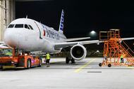 An American Airlines plane is towed into a maintenance hangar for service, Thursday, Aug....