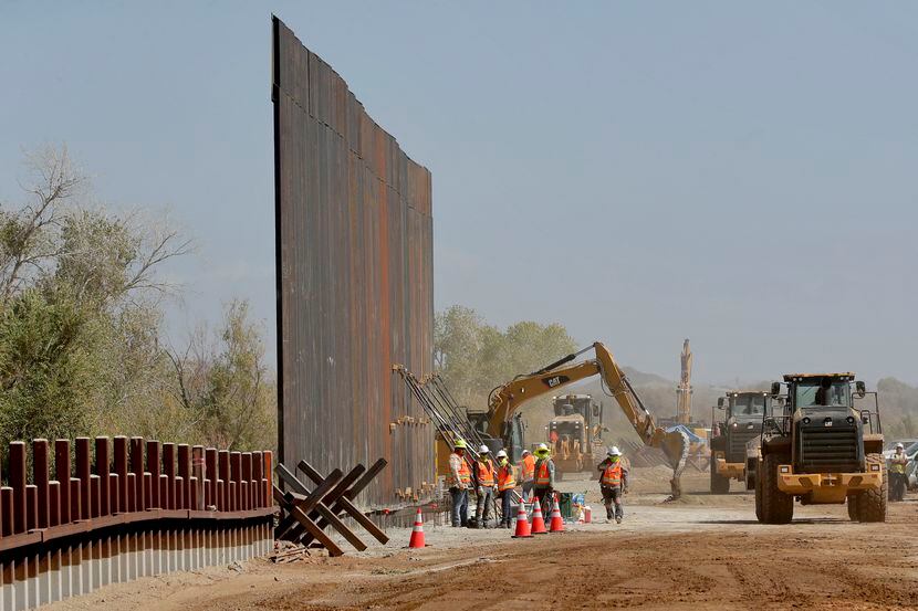 Government contractors erect a section of Pentagon-funded border wall along the Colorado...