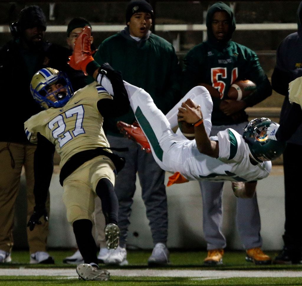 Lakeview DB Michael Ayers (27) upends Naaman Forest QB Jayden Flores (17) during the first...