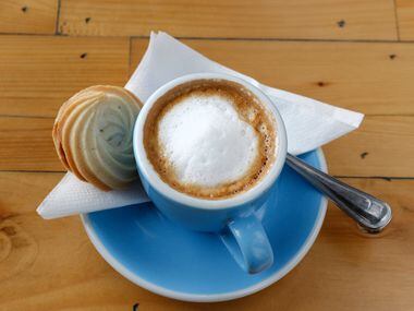 A cup of espresso macchiato servered with homemade nutella sugar cookie at Toasted Coffee +...