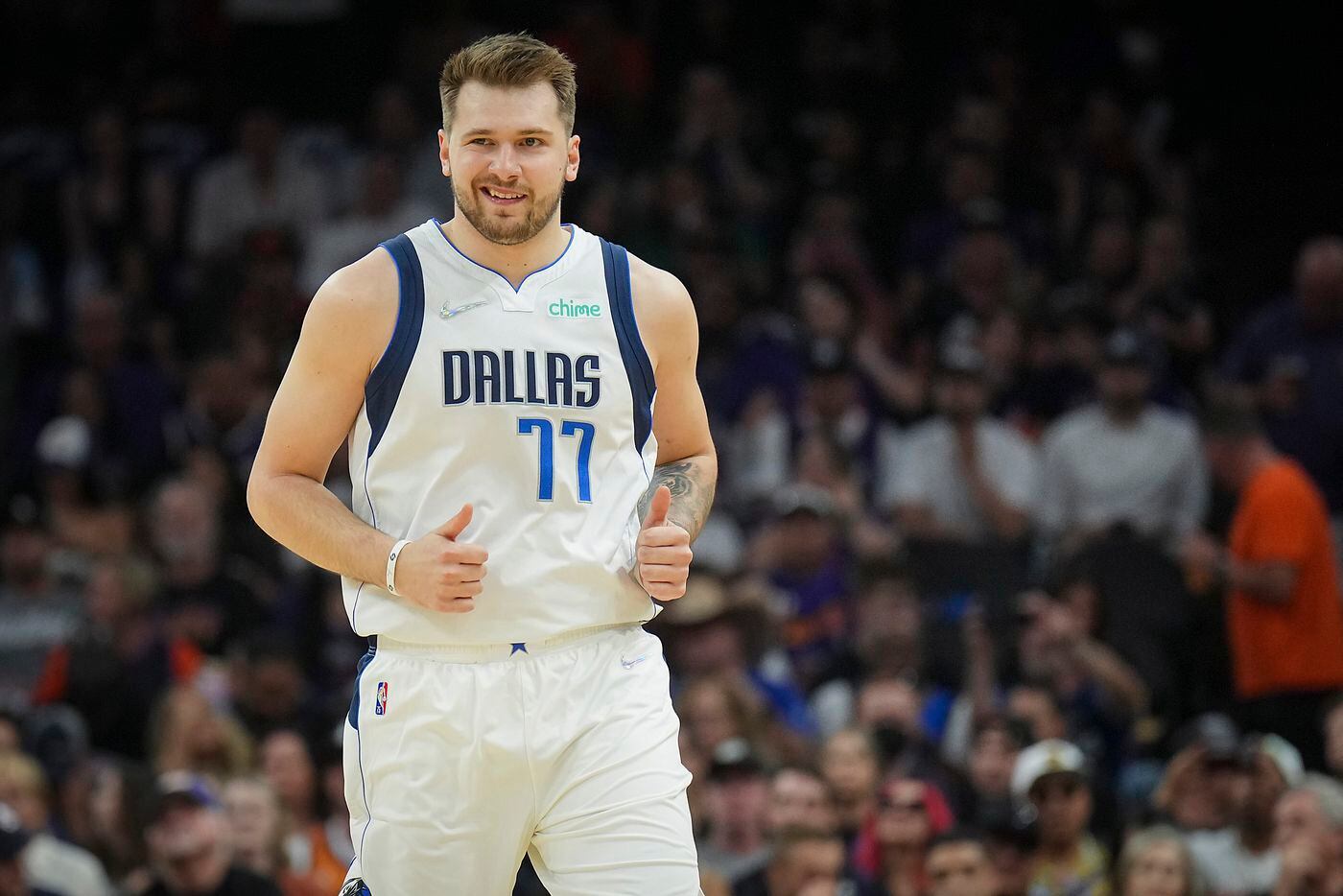 Dallas Mavericks guard Luka Doncic celebrates after hitting a 3-pointer during the first...