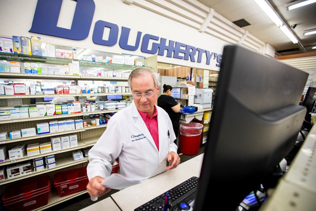 Pharmacist Jim Hawkins works behind the counter  at the flagship Dougherty's Pharmacy in Preston Royal Village.