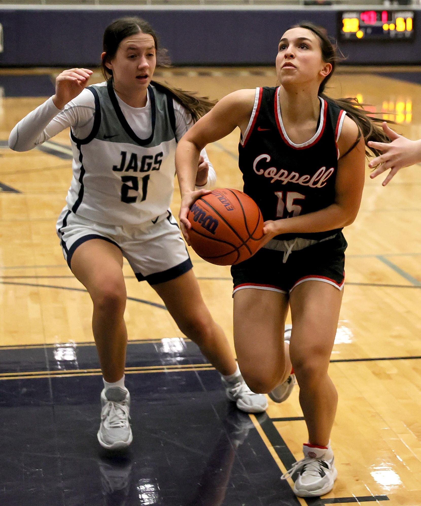 Coppell guard Atia Medenica (15) drives to the basket against Flower Mound guard Kaitlyn...