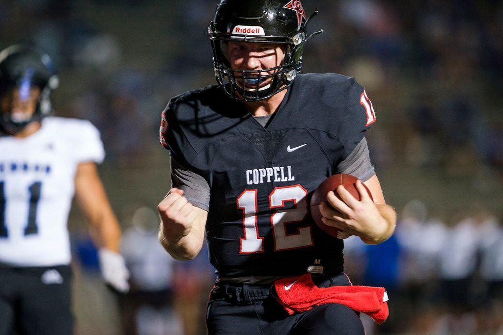 Coppell quarterback  Kevin Shuman celebrates as he scores on a touchdown run past Hebron...