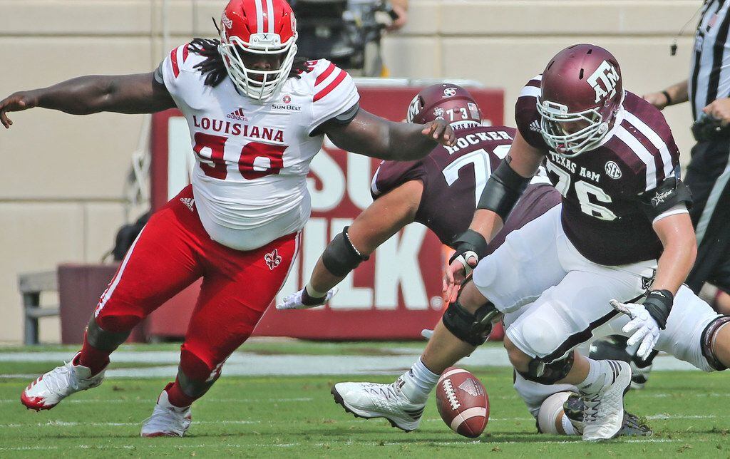 FILE - Louisiana-Lafayette defensive tackle Kevon Perry (90) and Texas A&M offensive lineman...