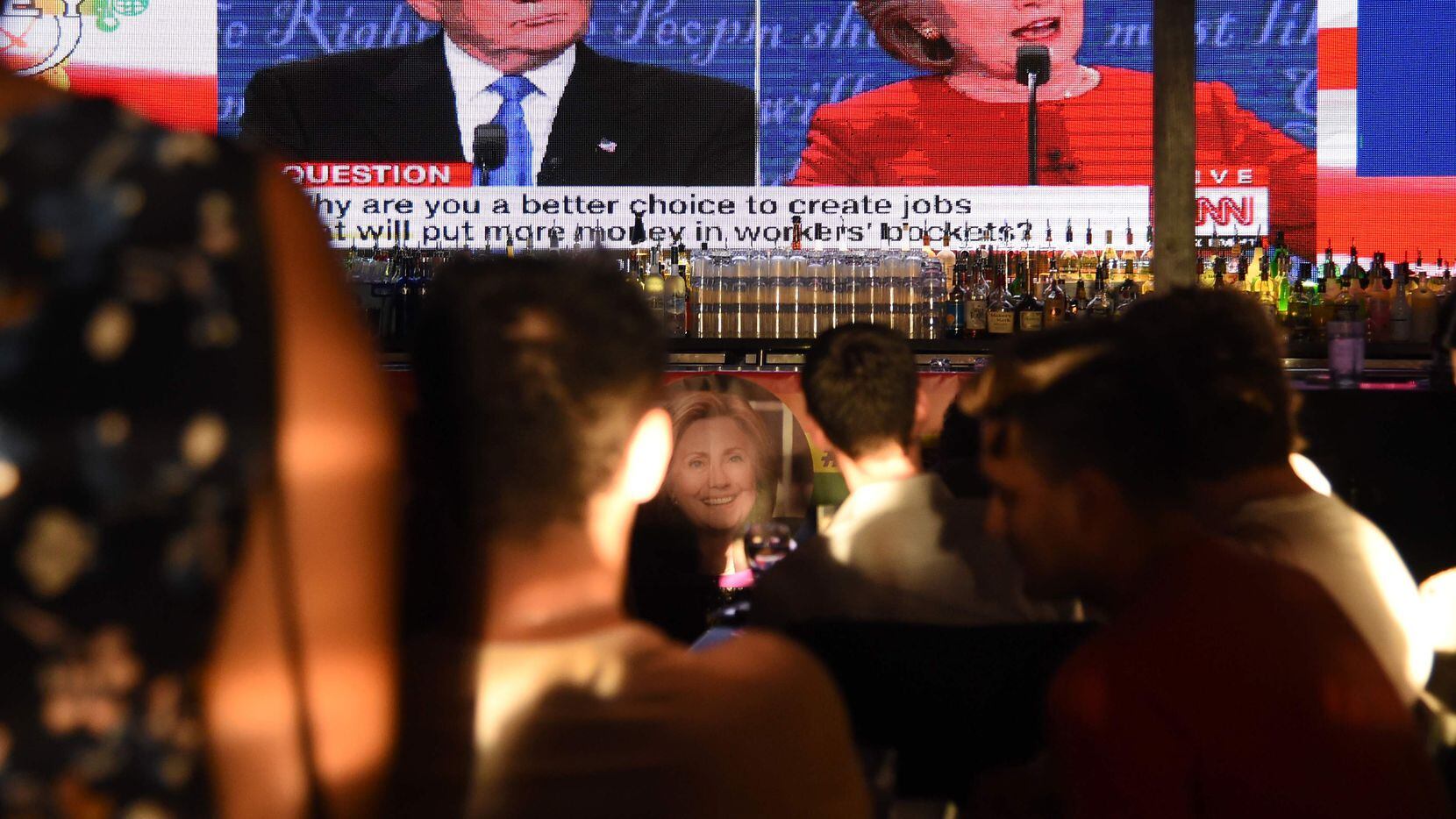 Clinton supporters watch the first presidential debate between Democratic candidate Hillary...