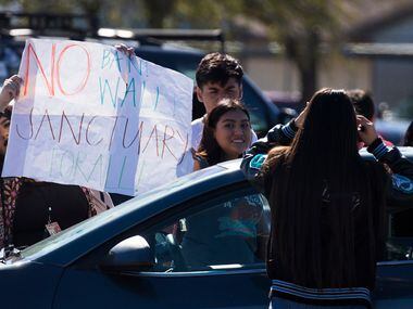 Students at Moises E. Molina High School walk out of class and rally in the parking lot in...