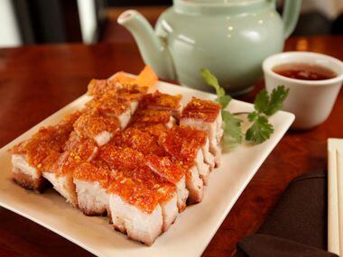 Roast pork, also known as roast suckling pig, at J.S. Chen's Dimsum and BBQ in Plano. The...