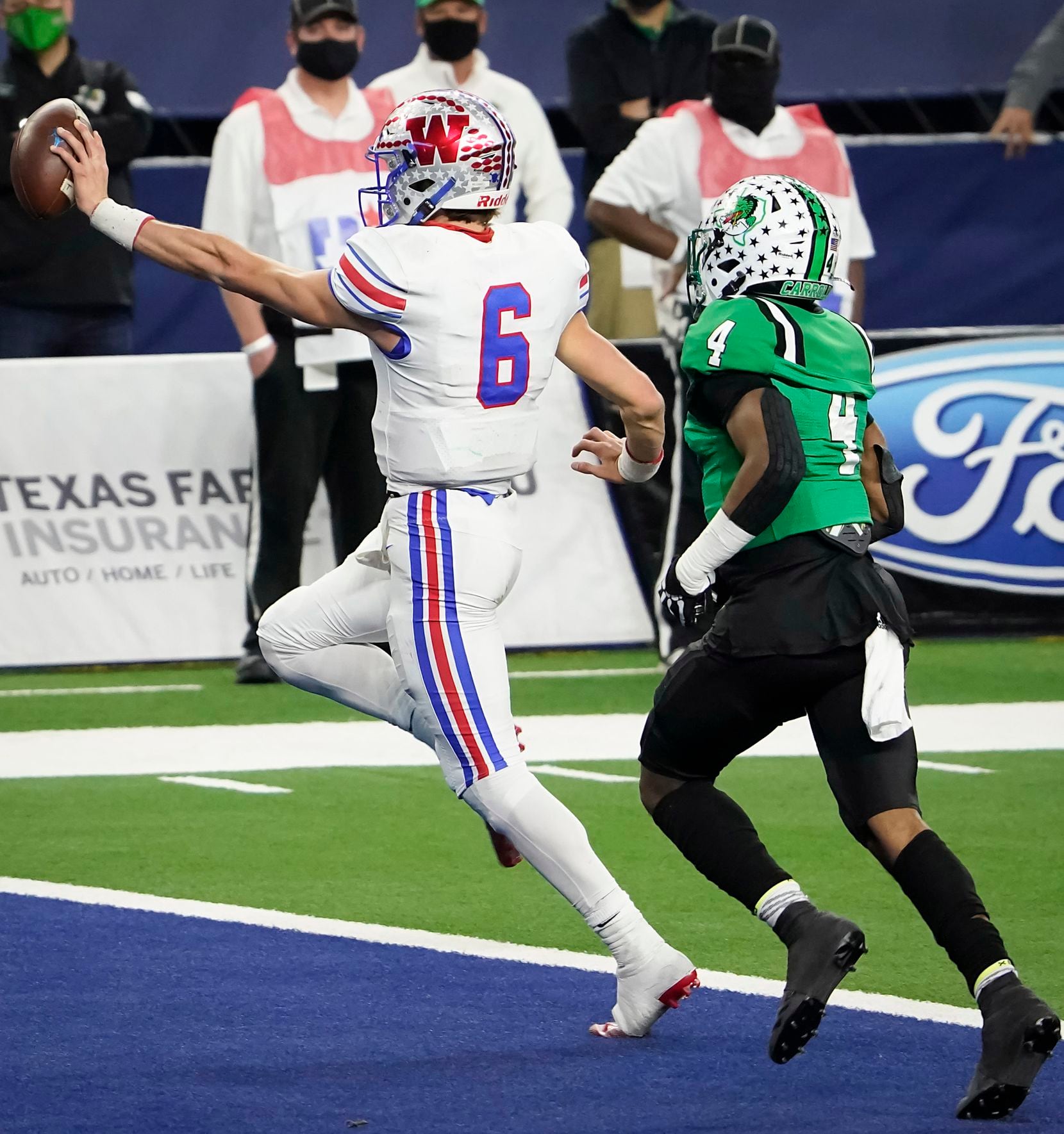 Austin Westlake quarterback Cade Klubnik (6) scores on a 1-yard touchdown run past Southlake Carroll defensive back Cinque Williams (4) during the second quarter of the Class 6A Division I state football championship game at AT&T Stadium on Saturday, Jan. 16, 2021, in Arlington, Texas.