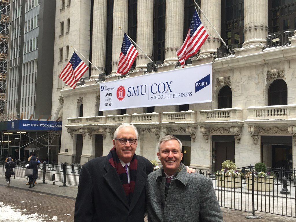 David Miller and his son, Kyle, stand in front of the New York Stock Exchange on Jan. 8 when...
