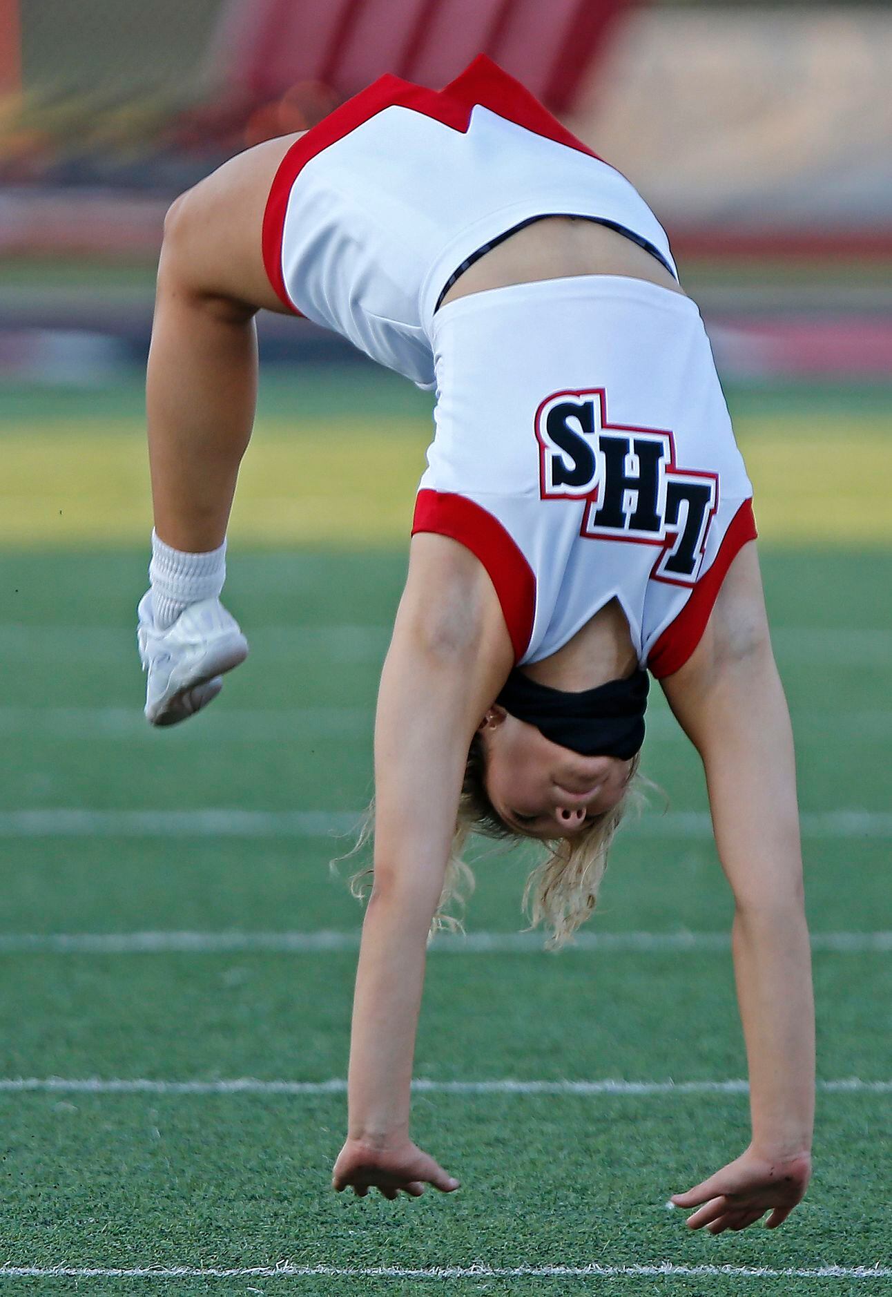 Heritage High School varsity cheerleader Grace Babic, 17, does back flips as the teams get...