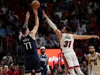 Dallas Mavericks guard Luka Doncic (77) aims to score as Miami Heat guard Max Strus (31)...