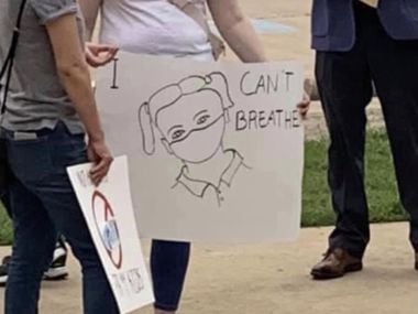 Protesters held "I can't breathe" signs outside the Carroll ISD board meeting Monday night, two days after two trustees who oppose the district's cultural competence plan were elected.