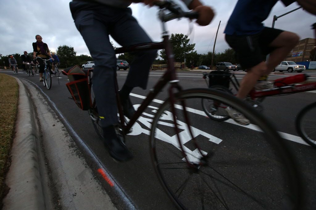 Cyclists ride in the bike lane at Zang and Colorado Boulevards in Oak Cliff. (Nathan...