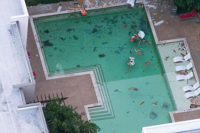Debris lies in the swimming pool after a tower crane fell from a construction site into Elan...