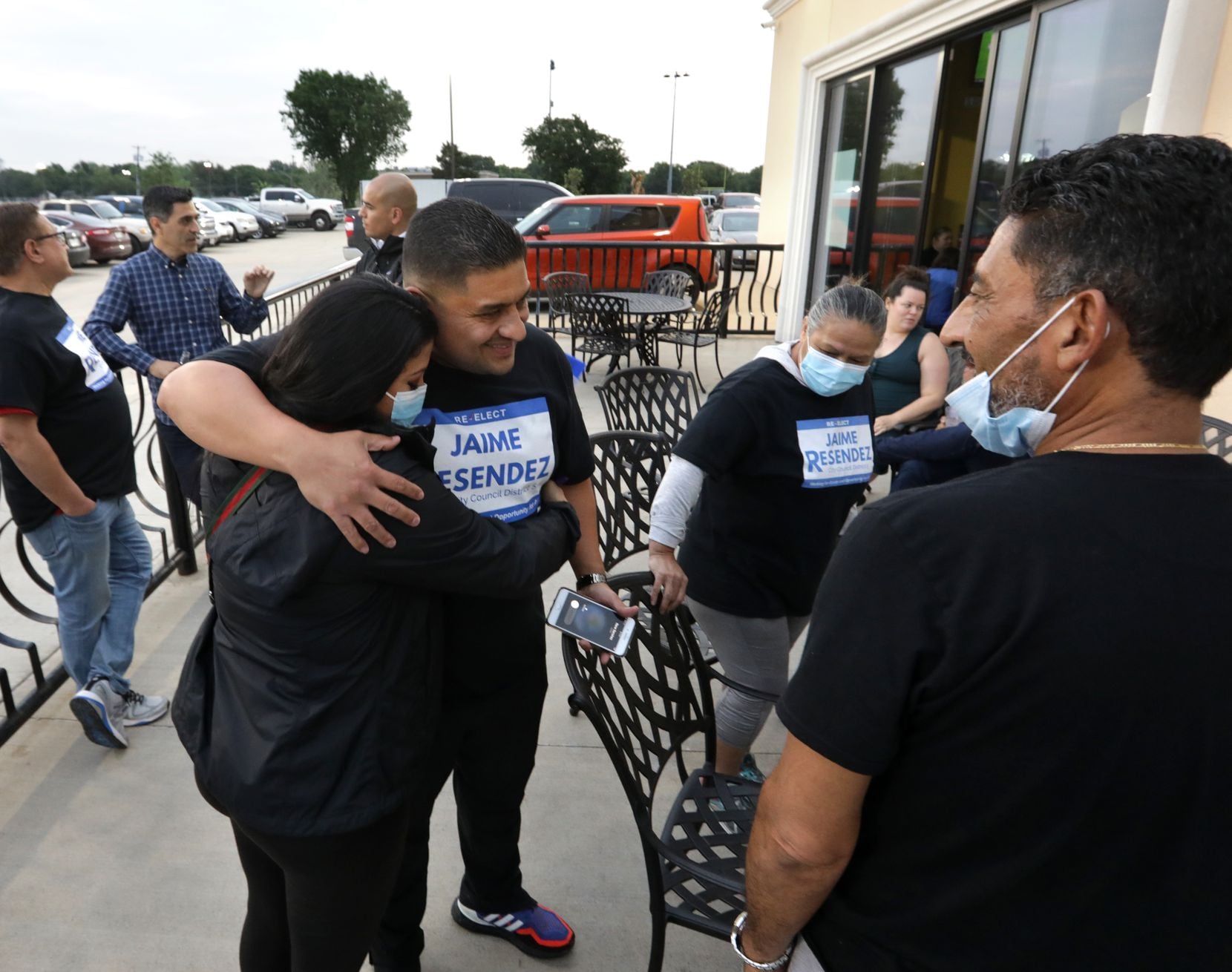 Victoria Resendez, left, and Jaime Resendez embrace as supporters keep an eye on the...