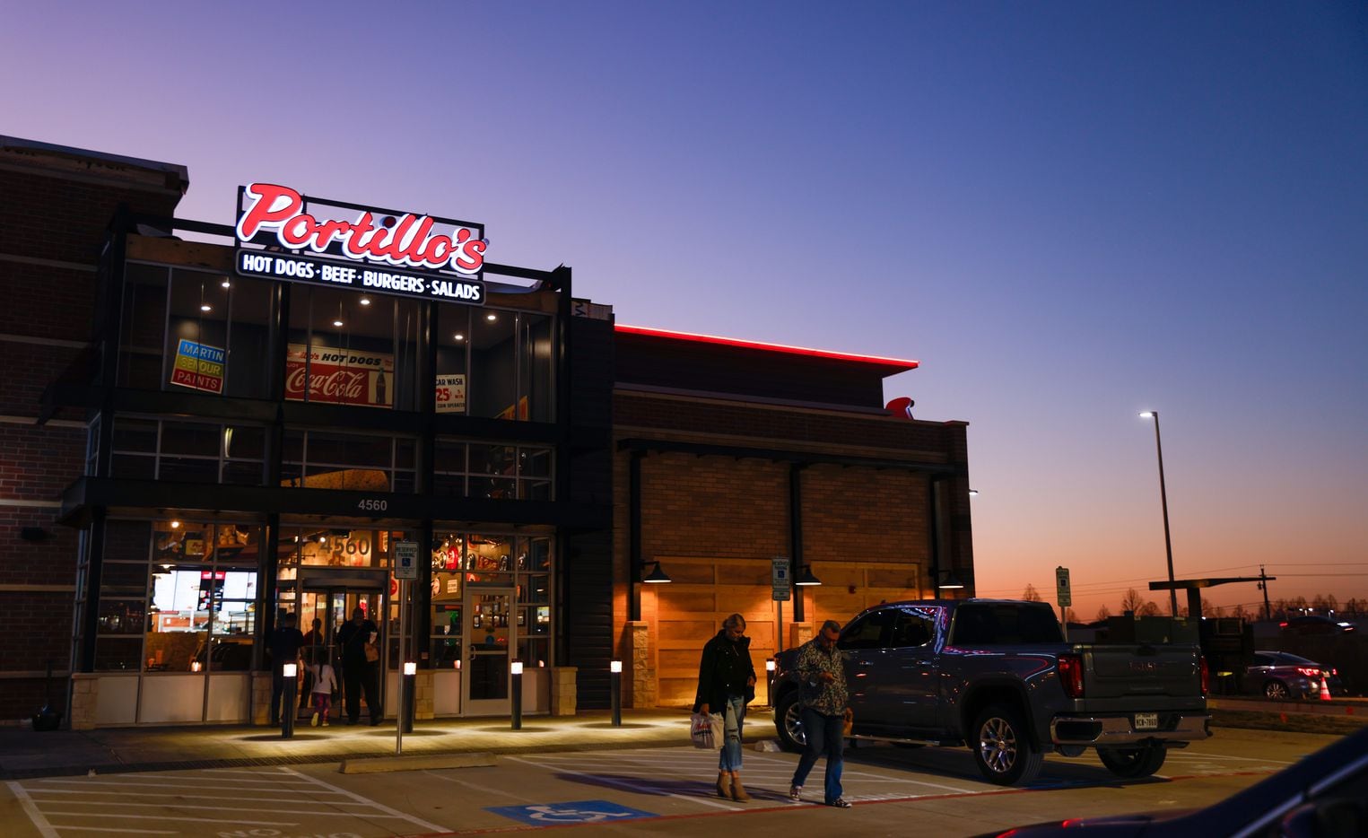 The sun sets behind Portillo’s on its first day open in The Colony on Monday, Jan. 9, 2023.