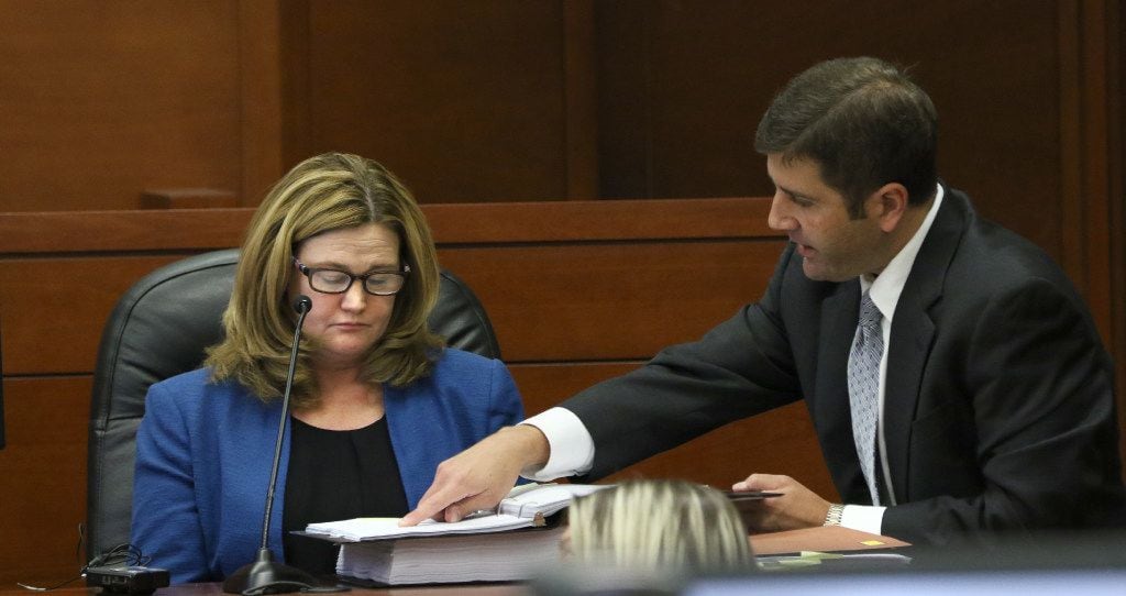 Executive Director Kelly Gottschalk is shown evidence by plaintiff's attorney Chris Ayres...