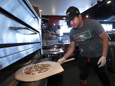Juan José Orosco makes pizza at In-Fretta in Plano on April 2, 2020.