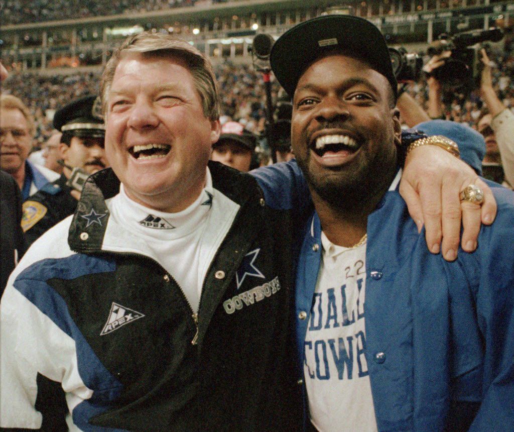 Dallas Cowboys coach Jimmy Johnson, left, and running  back Emmitt Smith celebrate as they...