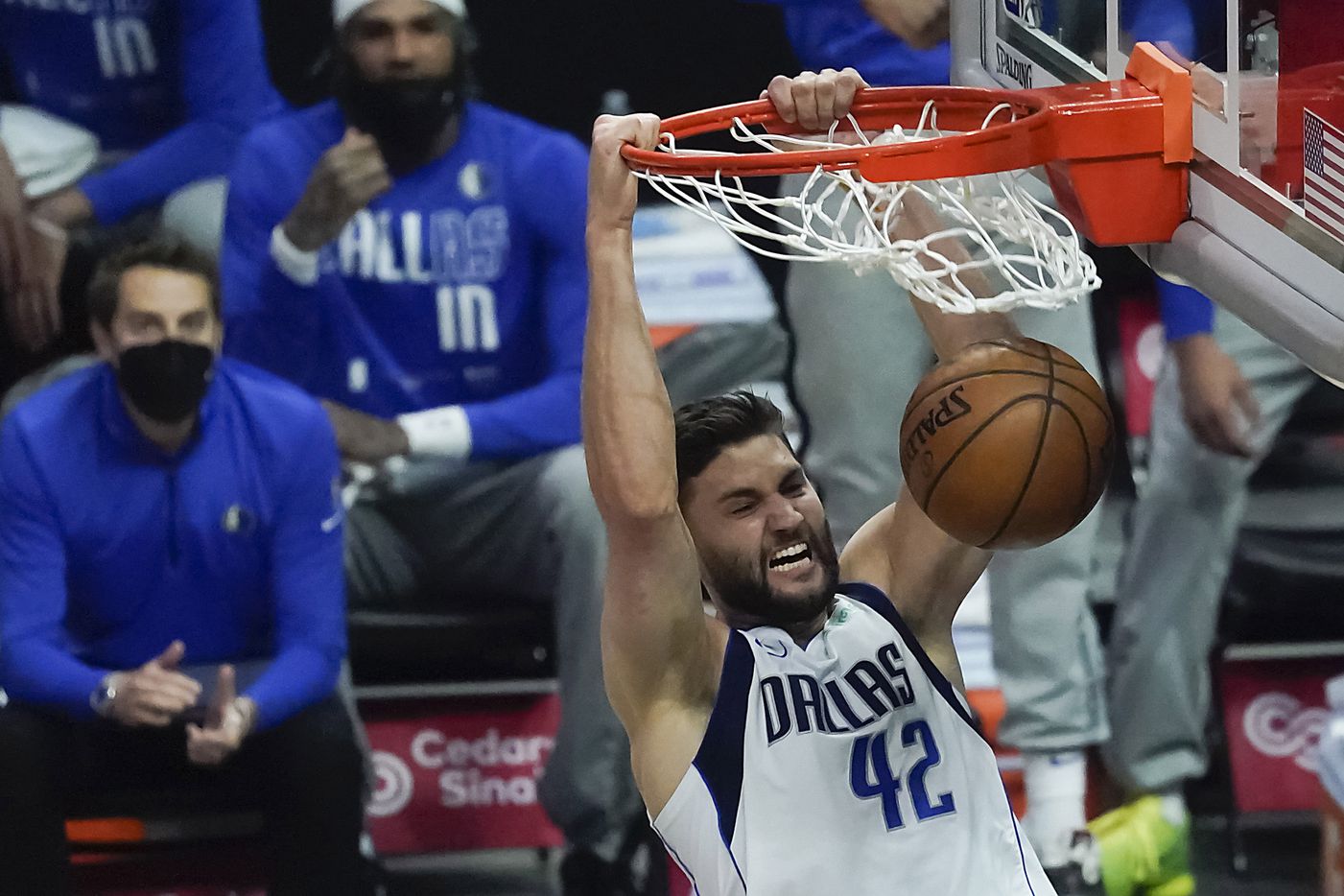 Dallas Mavericks forward Maxi Kleber dunks the ball past LA Clippers forward Marcus Morris Sr. during the first half of an NBA playoff basketball game at Staples Center on Tuesday, May 25, 2021, in Los Angeles.