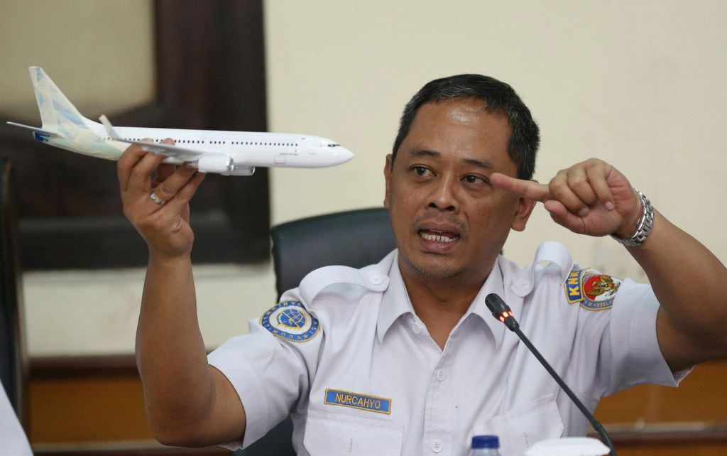 National Transportation Safety Committee investigator Nurcahyo Utomo holds a model of an...