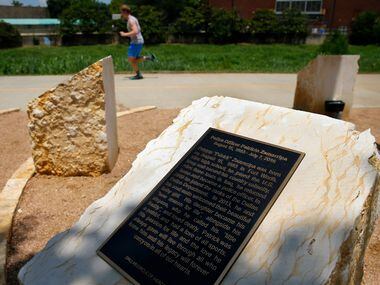 A runner on the Trinity Strand Trail passes the Circle of Heroes memorial unveiled Thursday,...