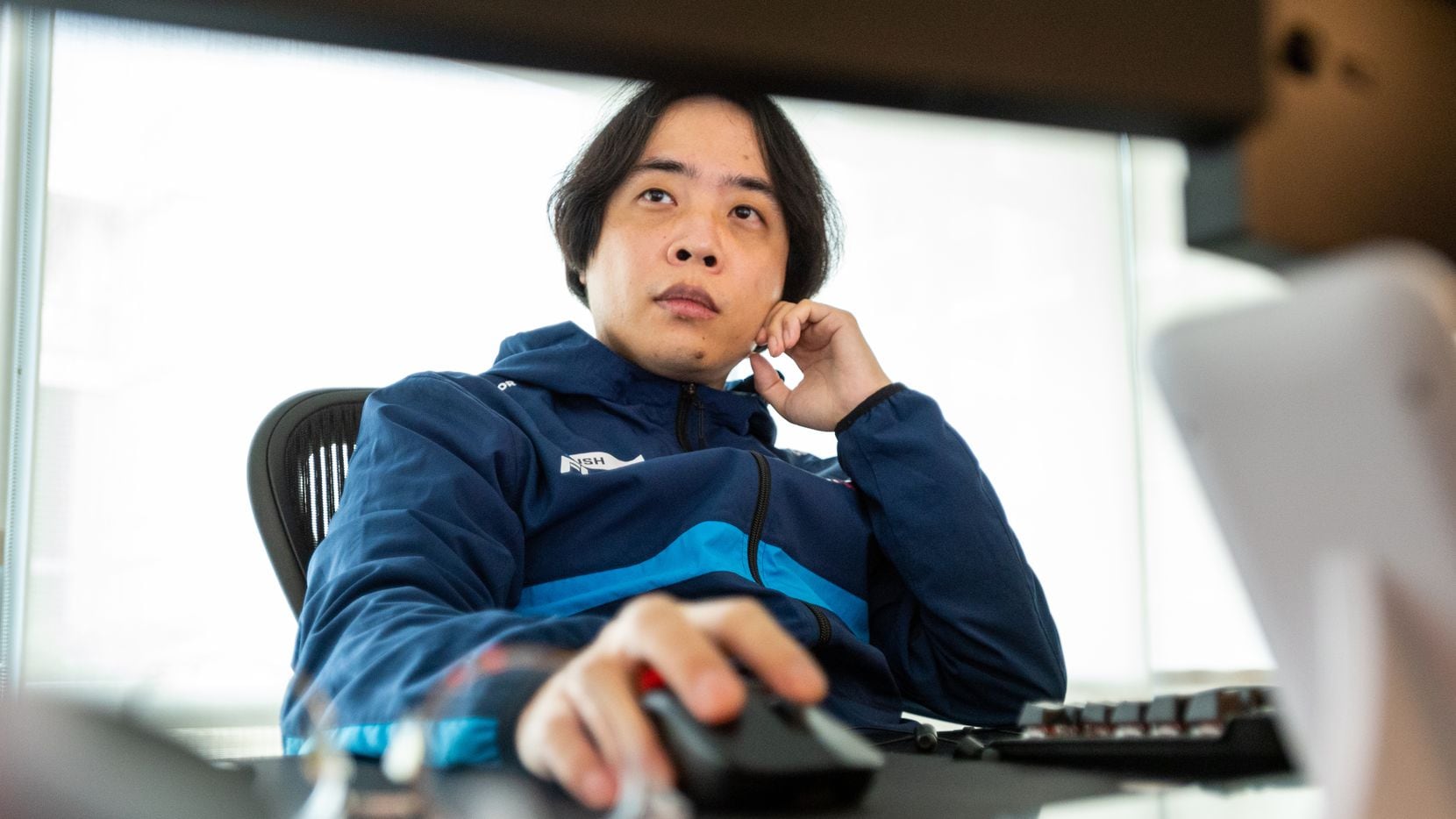 Dallas Fuel head coach Hee-Won "Rush" Yun studies game play on computer monitors during...
