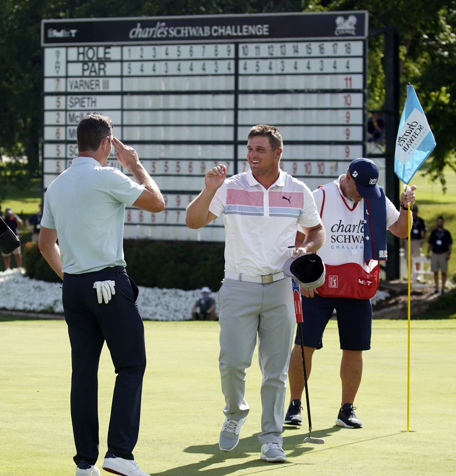 PGA Tour golfer Justin Rose salutes playing partner Bryson DeChambeau who gave him an air...