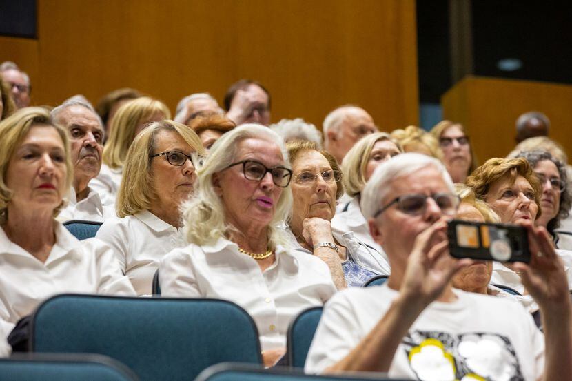 Opponents of Planned Development 15 wear white while attending the city council meeting on...