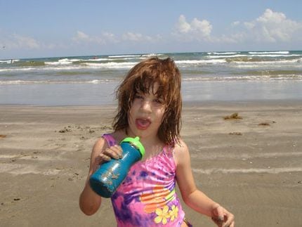 Kara Zartler at the beach in Galveston as a young girl. Her severe autism developed around...