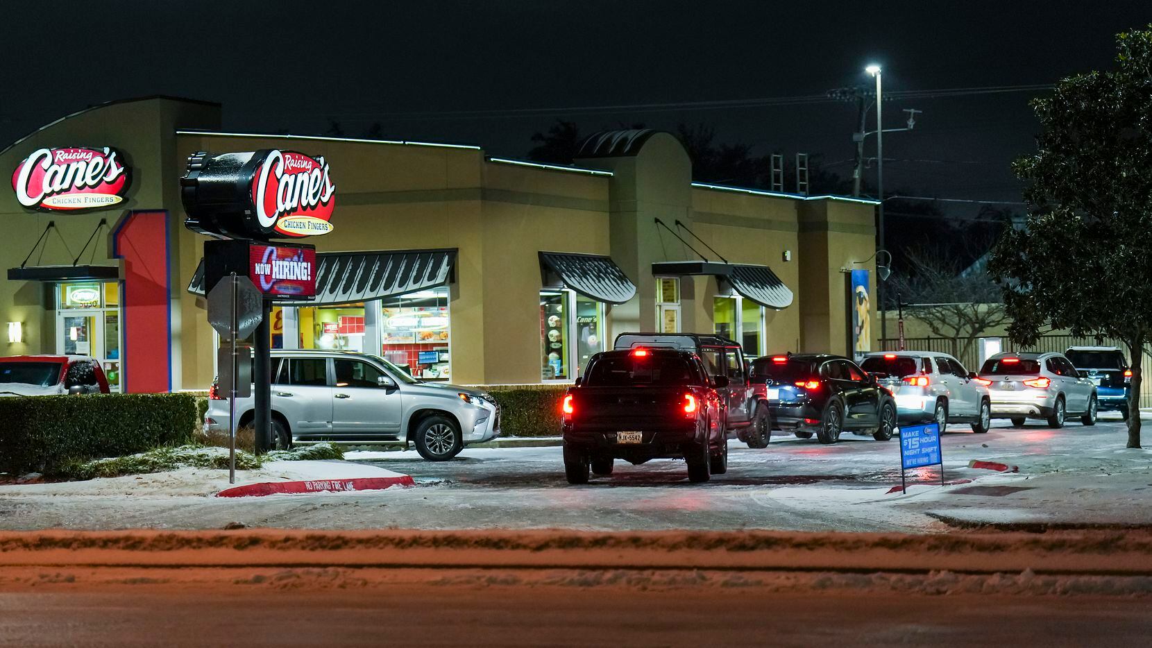 The drive through line wraps around a Raising Cane’s on Greenvile Avenue, one of the few...