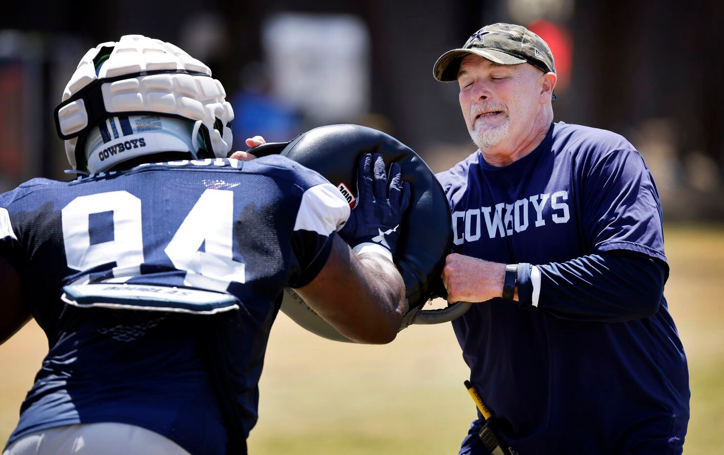 Dallas Cowboys defensive coordinator Dan Quinn winces as defensive tackle Josiah Bronson...